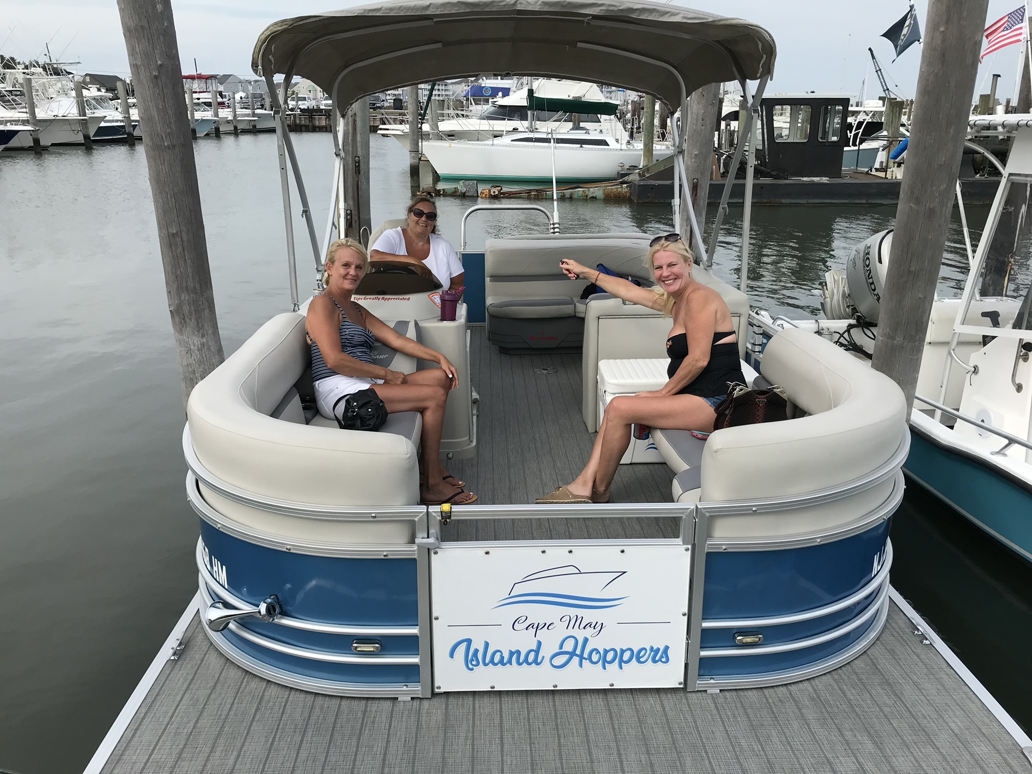 Three people seated on the Island Hoppers pontoon boat